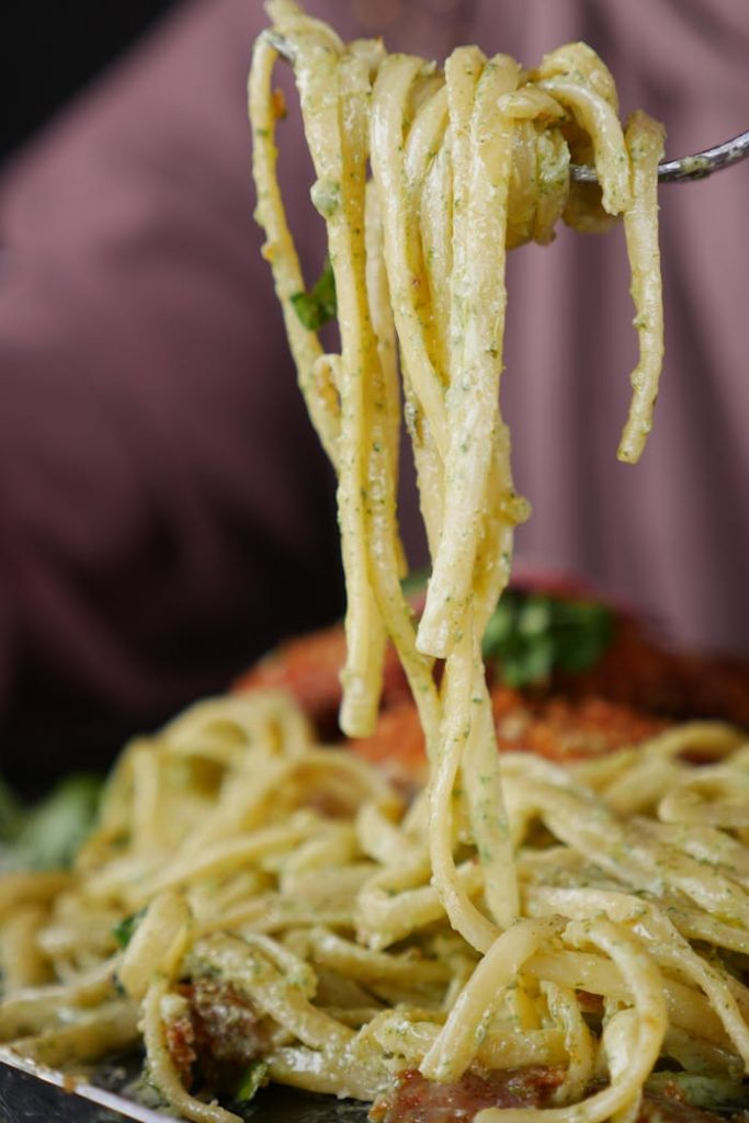 A fork is holding up a piece of spaghetti